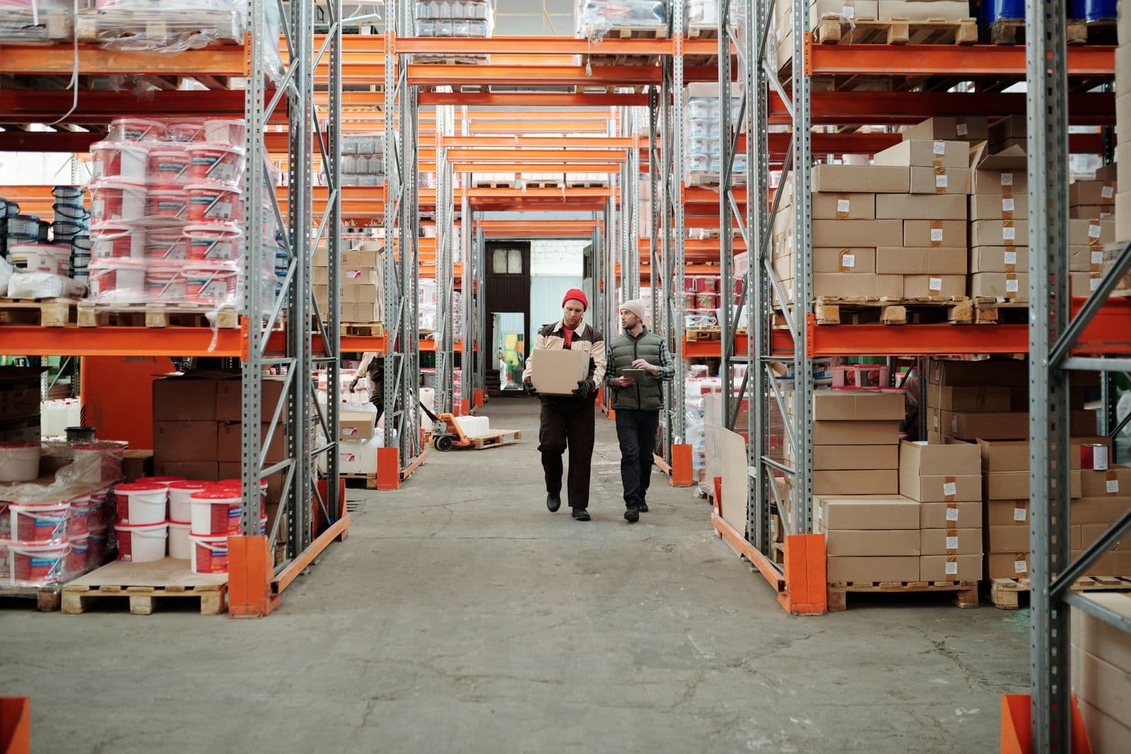 Two workers walking a warehouse aisle during a bounded pilot