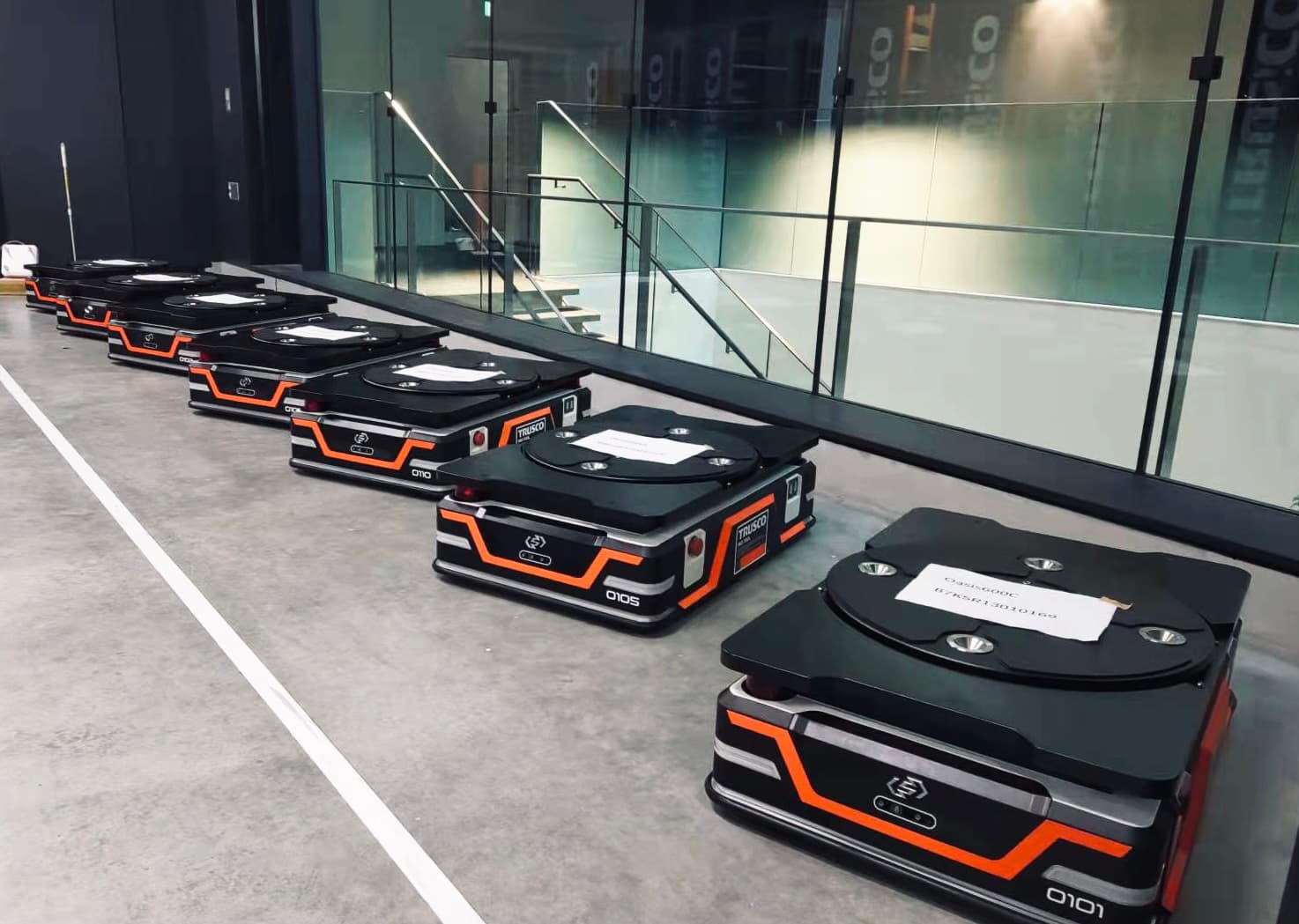 Row of autonomous mobile robot carts parked indoors