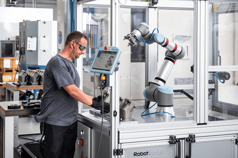 Collaborative robot arm tending a machine