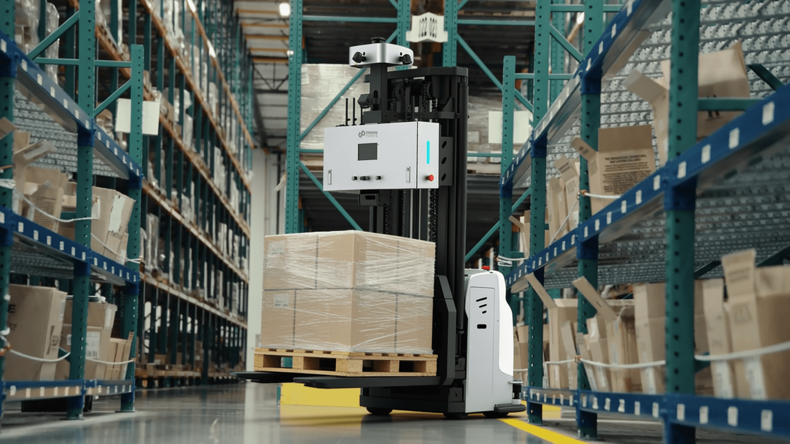An autonomous forklift moving a pallet across a factory floor