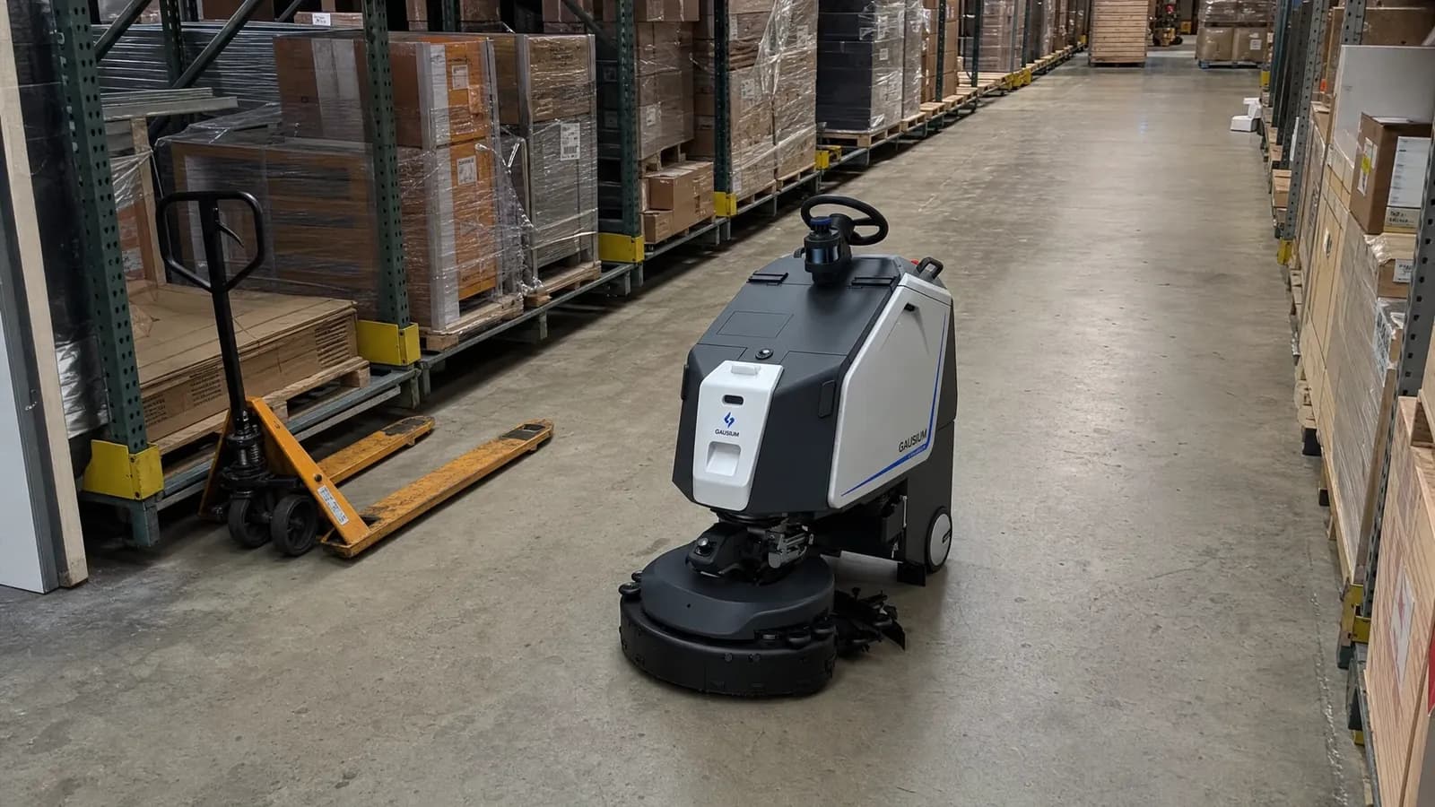 Gausium Scrubber 75 scrubbing a warehouse floor