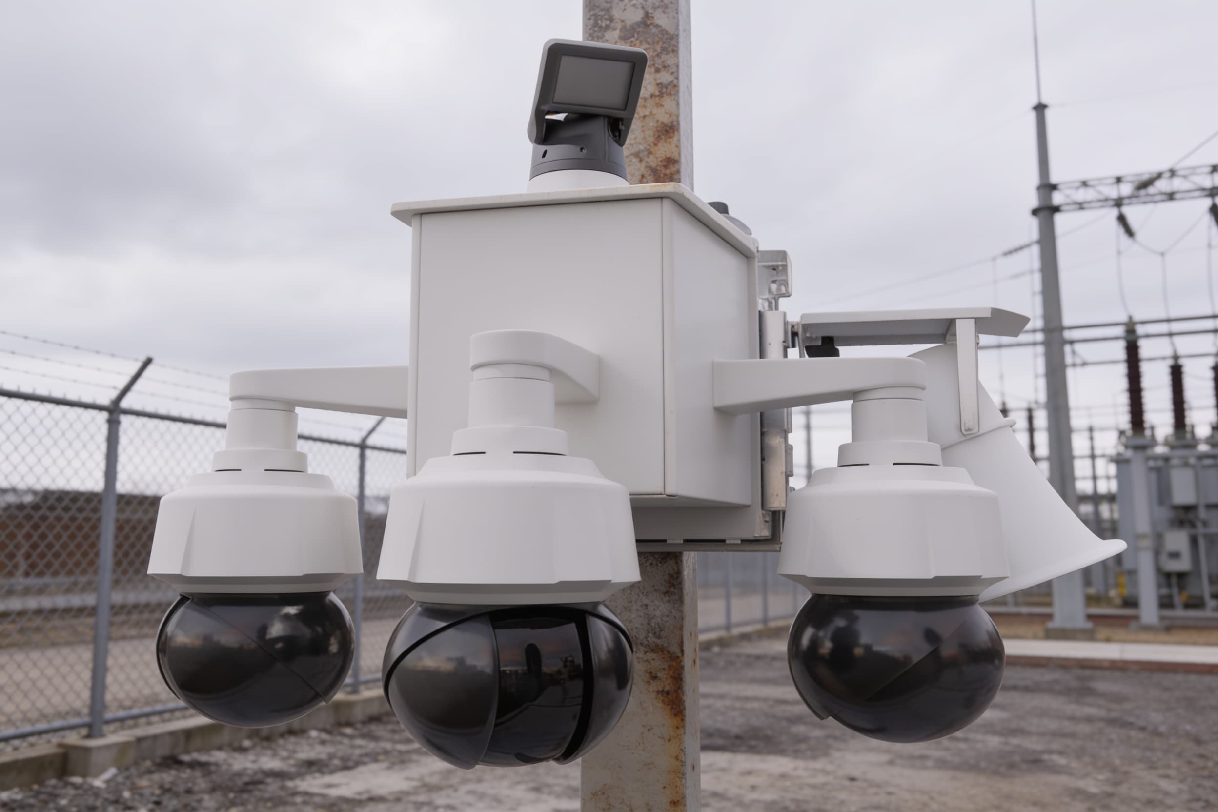 Security camera on a pole at a substation perimeter