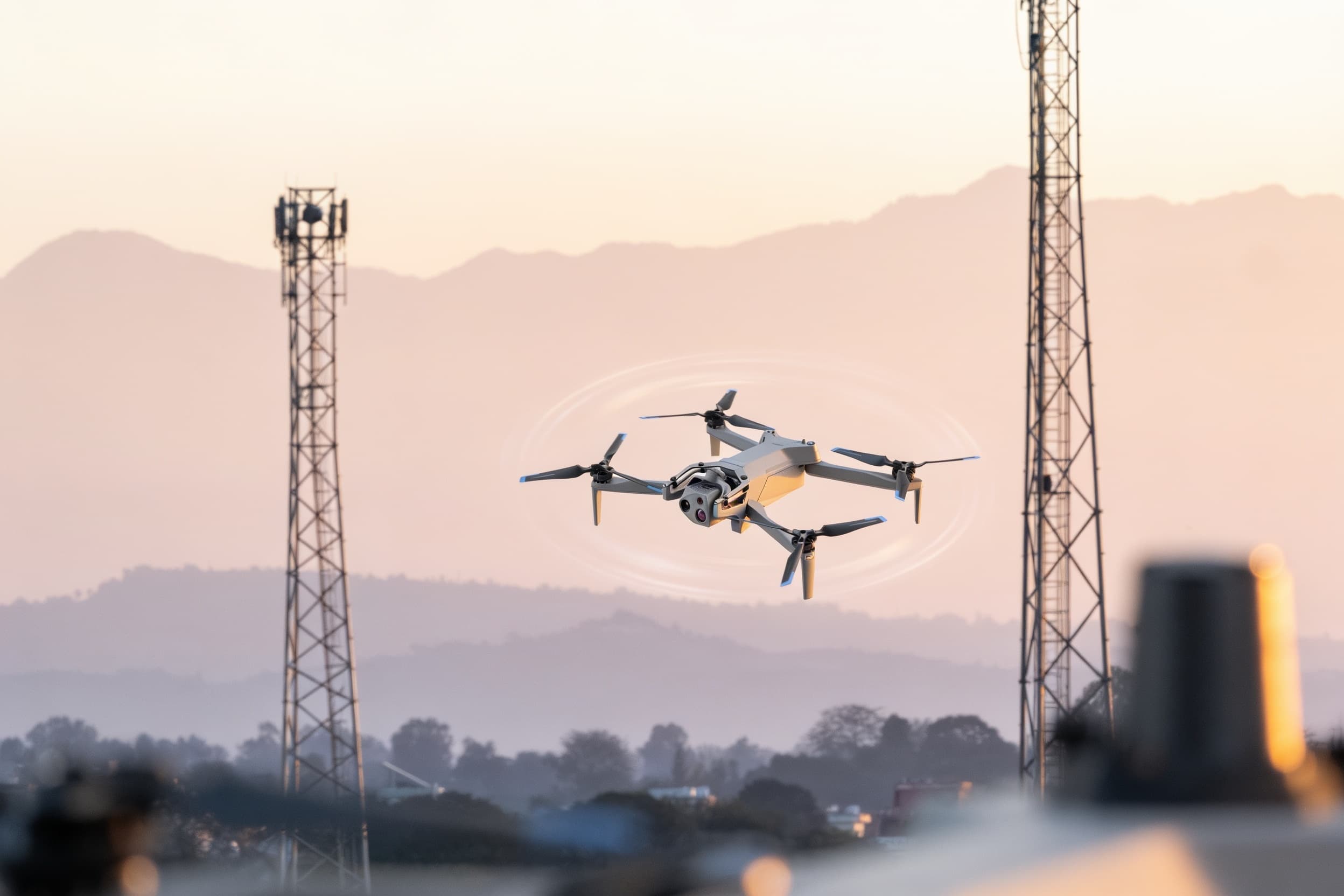 Reconnaissance drone orbiting a cell tower