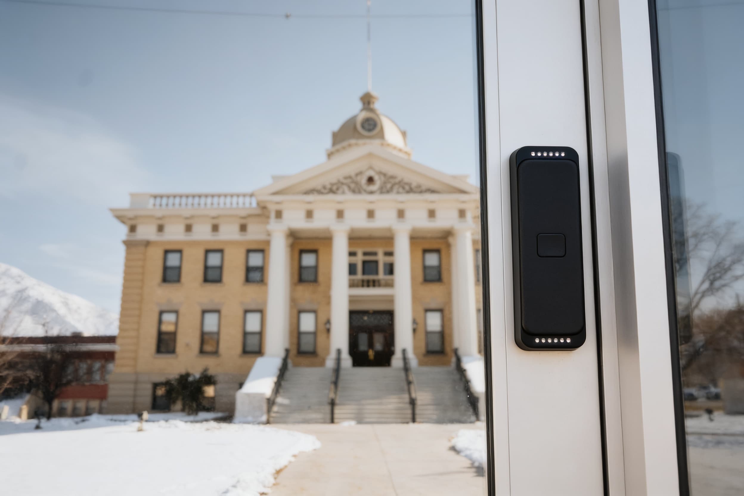 An access reader on the frame of the secure entrance door