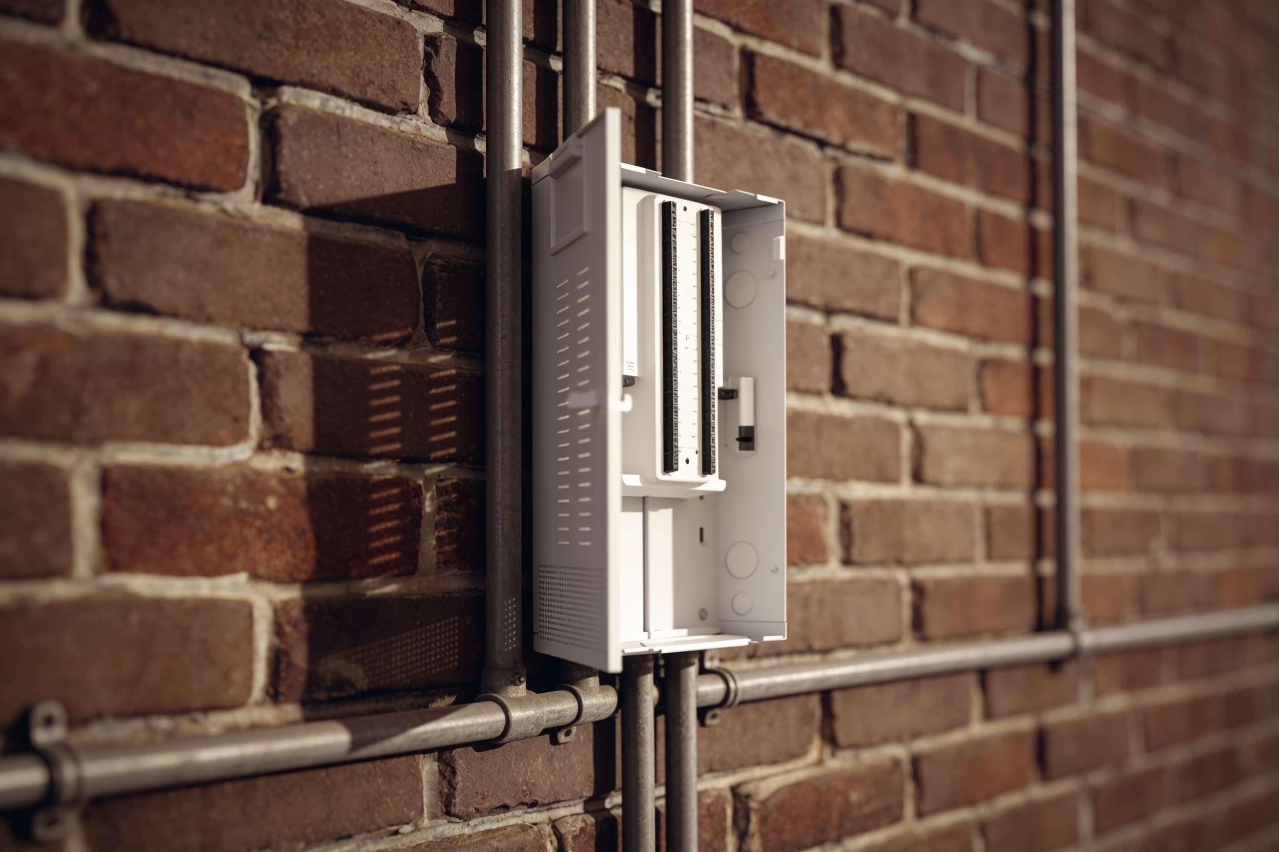 A wall-mounted security device mounted among the conduit runs